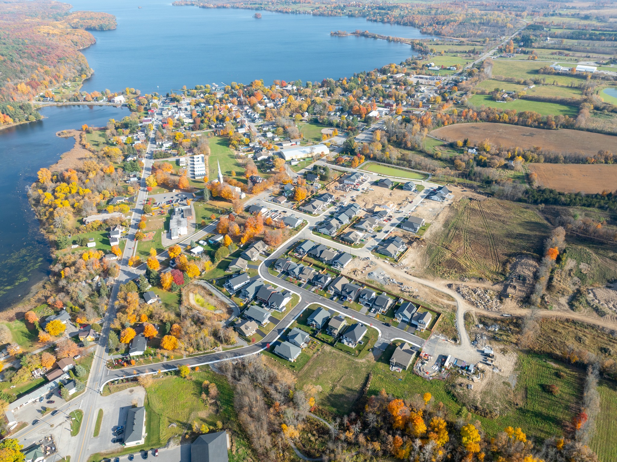 Moving to a small town near Kingston, aerial view of Westport Ontario showing the village core, waterfront, residential neighbourhoods, and surrounding countryside. Bill Stevenson, REALTOR®, Century 21 Lanthorn Real Estate Ltd., Brokerage.