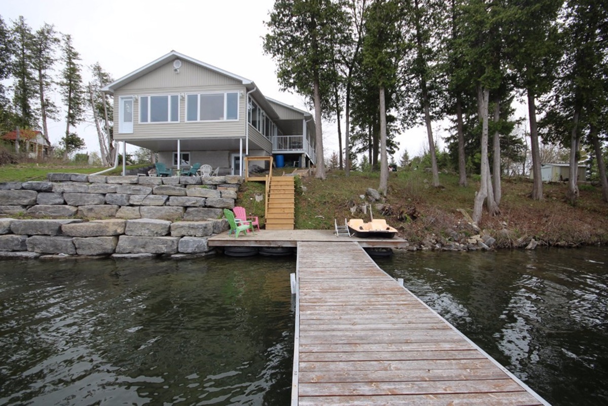 Moving to a small town near Kingston, waterfront home with private dock, shoreline improvements, and lake access illustrating waterfront living and lifestyle choices. Bill Stevenson, REALTOR®, Century 21 Lanthorn Real Estate Ltd., Brokerage.