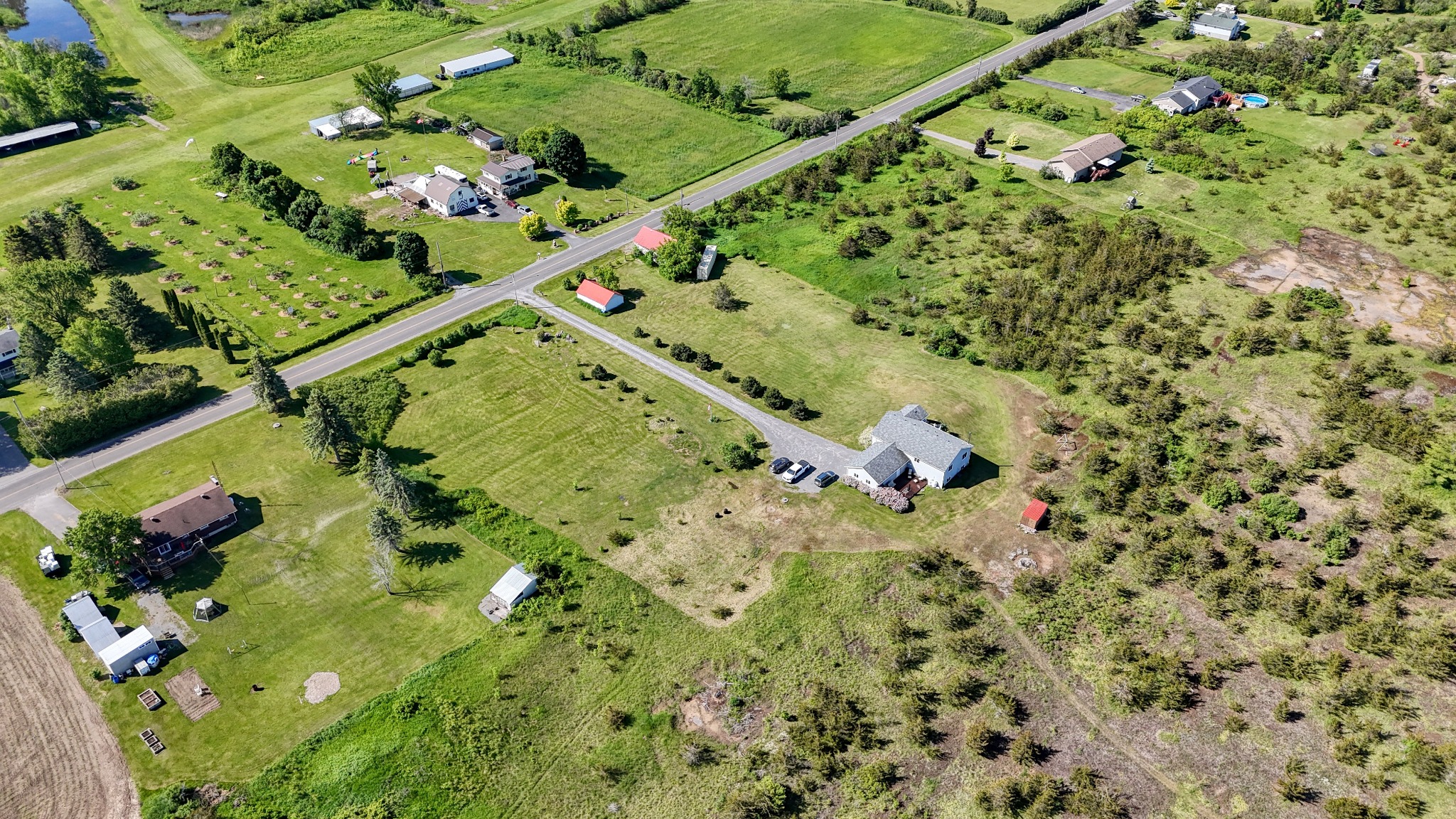 Aerial view of a rural Kingston area property with acreage, road access, and surrounding countryside, showing issues that can affect rural financing.