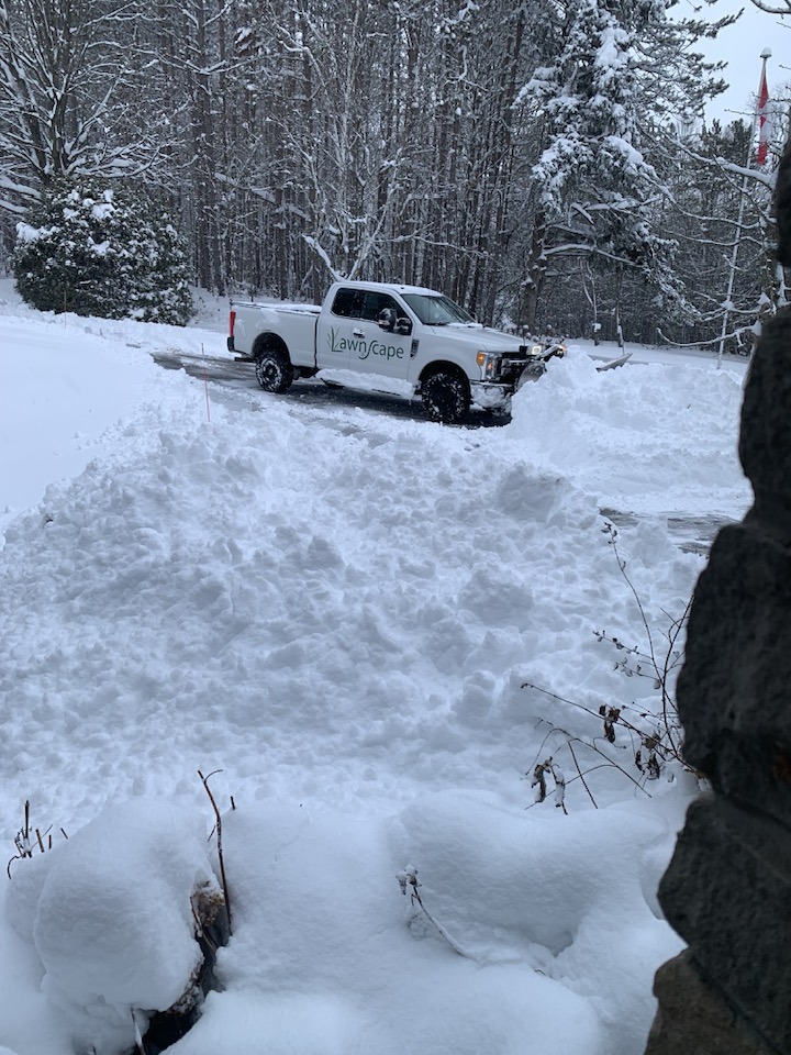 Snow removal on residential driveway in Kingston area showing winter home maintenance and access management